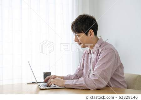 A man who operates a laptop computer A man who operates a laptop computer 62829140