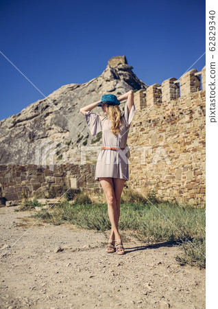 Young woman in fashionable clothes a summer dress Young woman in fashionable clothes a summer dress 62829340