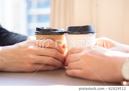 兩隻手拿著紙杯咖啡 兩隻手拿著紙杯咖啡 62829512