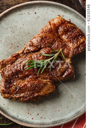 Two beef steak on dark gray background Two beef steak on dark gray background 62830546