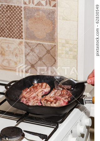 Raw beef steak in grill pan Raw beef steak in grill pan 62830549