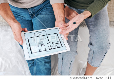 View of hands of young couple in casualwear consulting about plan of new flat 62830811