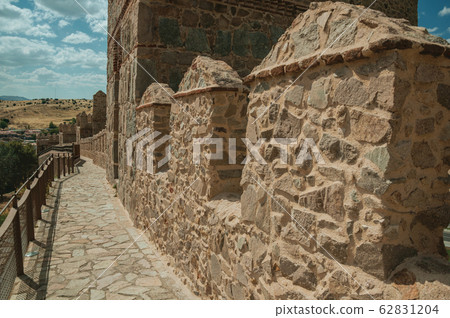 Pathway over old thick wall encircling the town of Avila Pathway over old thick wall encircling the town of Avila 62831204