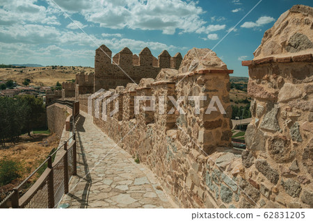 Pathway over old thick wall encircling the town of Avila Pathway over old thick wall encircling the town of Avila 62831205
