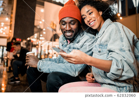 Happy pretty lady is using smartphone outdoors Happy pretty lady is using smartphone outdoors 62832060