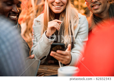 Happy pretty female holding smartphone and looking on screen Happy pretty female holding smartphone and looking on screen 62832343