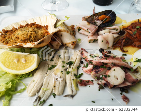 course and plate of hot seafood appetizer course and plate of hot seafood appetizer 62832344