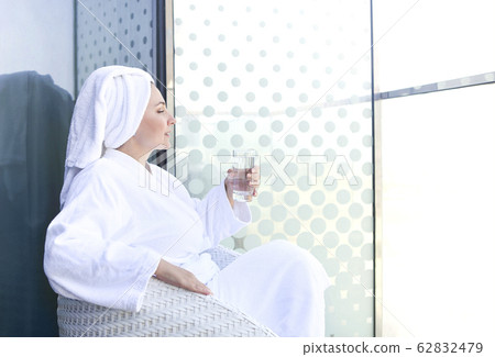 Lady having relaxation with glass of water after 62832479