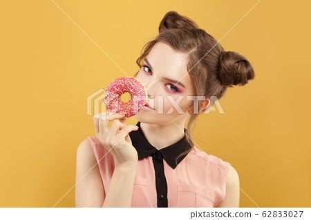 Cute fashion model woman with donut on vivid Cute fashion model woman with donut on vivid 62833027