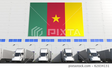 Trailer trucks at warehouse loading dock with flag of CAMEROON. Cameroonian logistics related conceptual 3D rendering 62834131