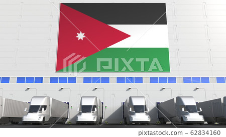 Trailer trucks at warehouse loading bay with flag of JORDAN. Jordanian logistics related conceptual 3D rendering 62834160
