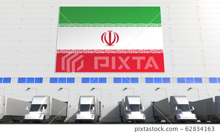 Semi-trailer trucks at warehouse loading dock with flag of IRAN. Iranian logistics related conceptual 3D rendering 62834163