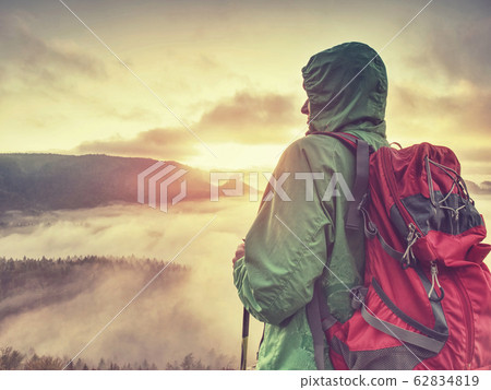 Tourist in windcheater with backpack enjoy amazing 62834819