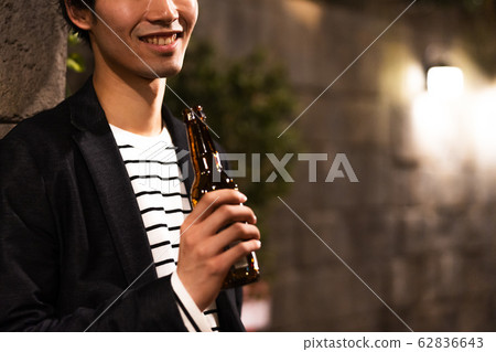 Young man (beer, night, drinking out, outdoor Young man (beer, night, drinking out, outdoor 62836643