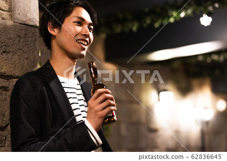 Young man (beer, night, drinking out, outdoor 62836645