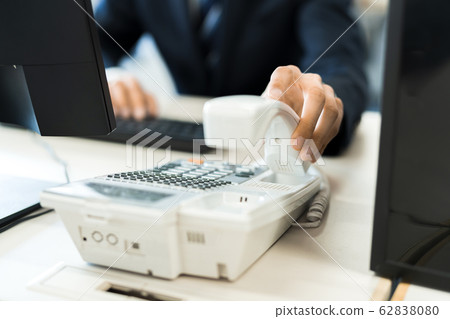 Young businessman (telephone, office, suit, desk work Young businessman (telephone, office, suit, desk work 62838080