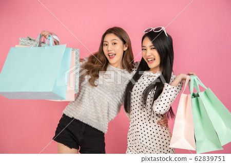 Asian pretty young woman sitting on pink pastel Asian pretty young woman sitting on pink pastel 62839751