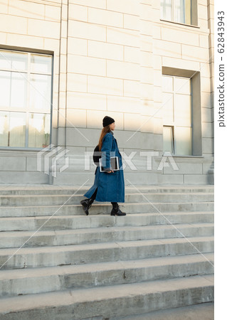 a young girl freelancer illustrator is holding a 62843943