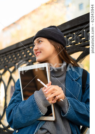 a young girl freelancer illustrator is holding a 62843944