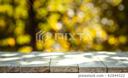 White wooden plank behind blur, orange-green bokeh White wooden plank behind blur, orange-green bokeh 62844322