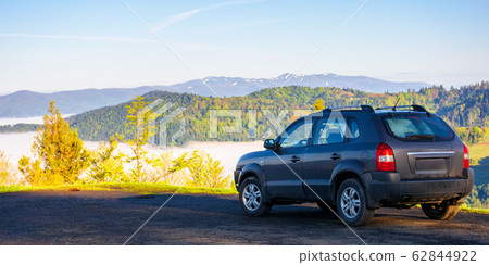 suv on the edge of a mountain suv on the edge of a mountain 62844922