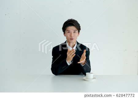 A business man who introduces himself and talks before the main subject 62847772