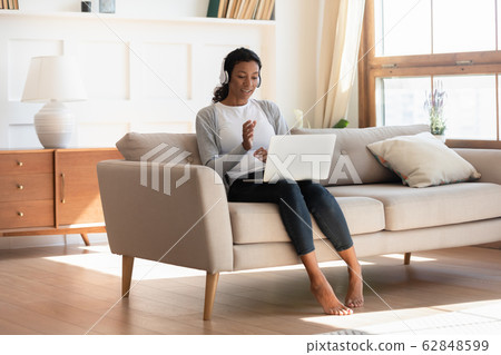 Young biracial woman in headphones talk on video call 62848599