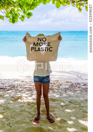 Young girl holding bag with sign No More plastic Young girl holding bag with sign No More plastic 62849687