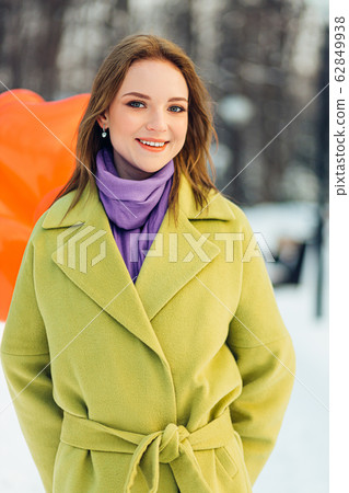portrait of beautiful caucasian woman smiling at camera outdoors 62849938