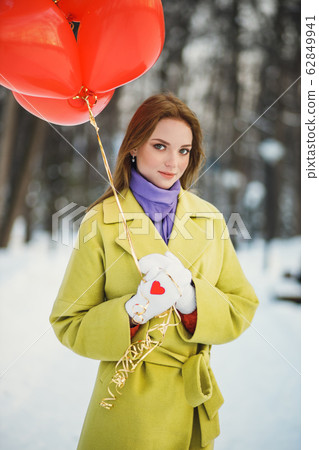 charming lady in coat with air balloons 62849941