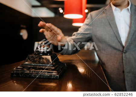 t the guy clicks on the bell at the reception of 62852246