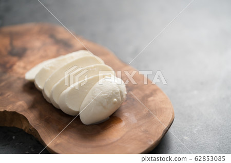 sliced mozzarella cheese on olive wood board sliced mozzarella cheese on olive wood board 62853085
