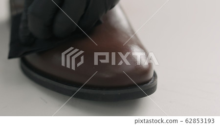 man hands in black gloves applying protective cream to brown leather chukka boots man hands in black gloves applying protective cream to brown leather chukka boots 62853193