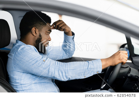 Depressed Man Sitting In Driver's Seat Of Too Expensive Car Depressed Man Sitting In Driver's Seat Of Too Expensive Car 62854078