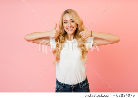 Like it. Pretty girl showing thumbs up with both hands Like it. Pretty girl showing thumbs up with both hands 62854079