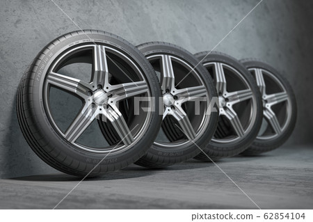 Car wheels. Four new black tyres with alloy discs in garage. Car wheels. Four new black tyres with alloy discs in garage. 62854104