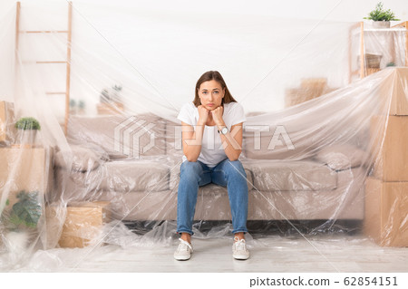 Young sad woman unhappy about new repair in her home Young sad woman unhappy about new repair in her home 62854151