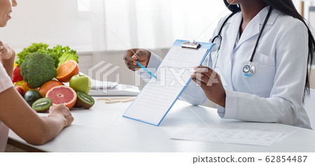 Cropped of nutritionist doctor consultating patient at modern clinic Cropped of nutritionist doctor consultating patient at modern clinic 62854487