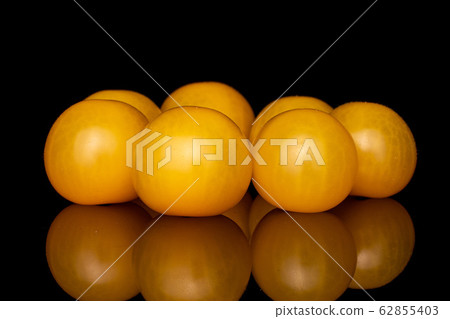 Fresh yellow tomato isolated on black glass Fresh yellow tomato isolated on black glass 62855403