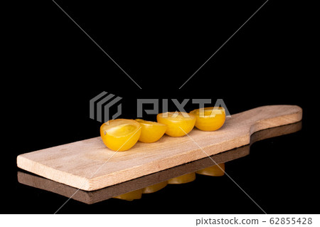 Fresh yellow tomato isolated on black glass Fresh yellow tomato isolated on black glass 62855428
