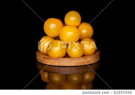 Fresh yellow tomato isolated on black glass Fresh yellow tomato isolated on black glass 62855456