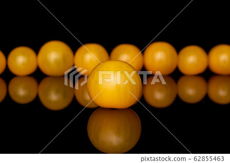 Fresh yellow tomato isolated on black glass Fresh yellow tomato isolated on black glass 62855463