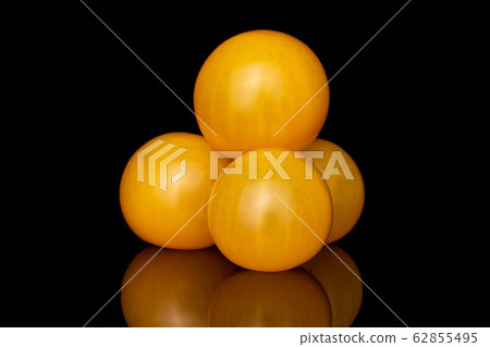 Fresh yellow tomato isolated on black glass Fresh yellow tomato isolated on black glass 62855495