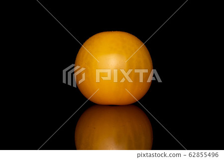 Fresh yellow tomato isolated on black glass Fresh yellow tomato isolated on black glass 62855496