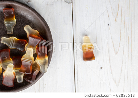 Sweet jelly cola on grey wood 62855518