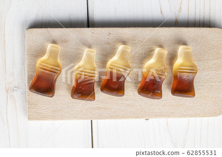 Sweet jelly cola on grey wood Sweet jelly cola on grey wood 62855531