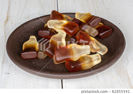 Sweet jelly cola on grey wood 62855541