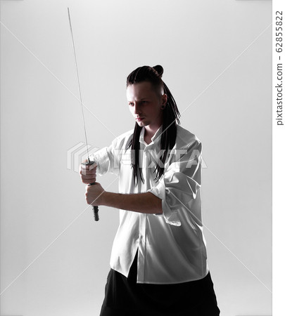 Young man holding a samurai sword. Glamour photo. 62855822