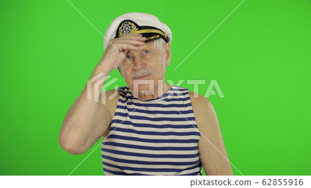Elderly sailor man with mustache smiling. Old sailorman on chroma key 62855916