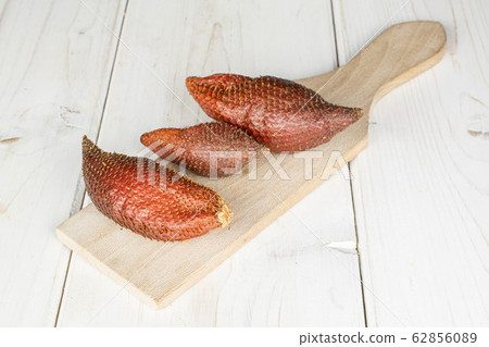 Exotic brown salak on grey wood 62856089